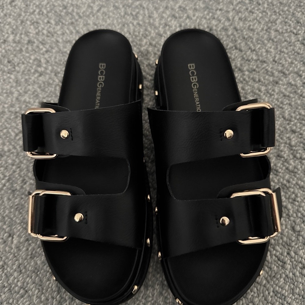 BCBGeneration Black Sandals with Gold Accents